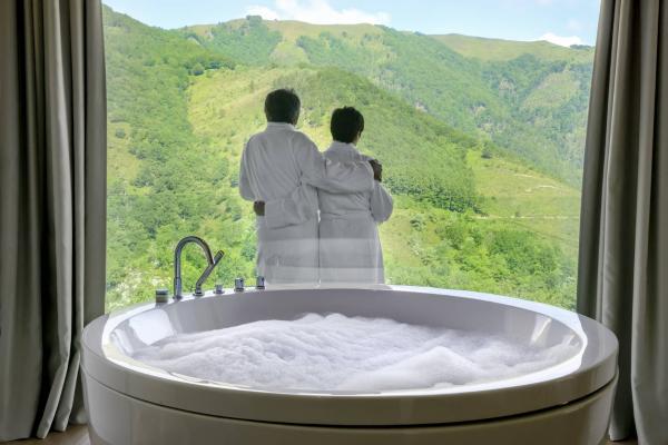 Couple looking out of hotel room window